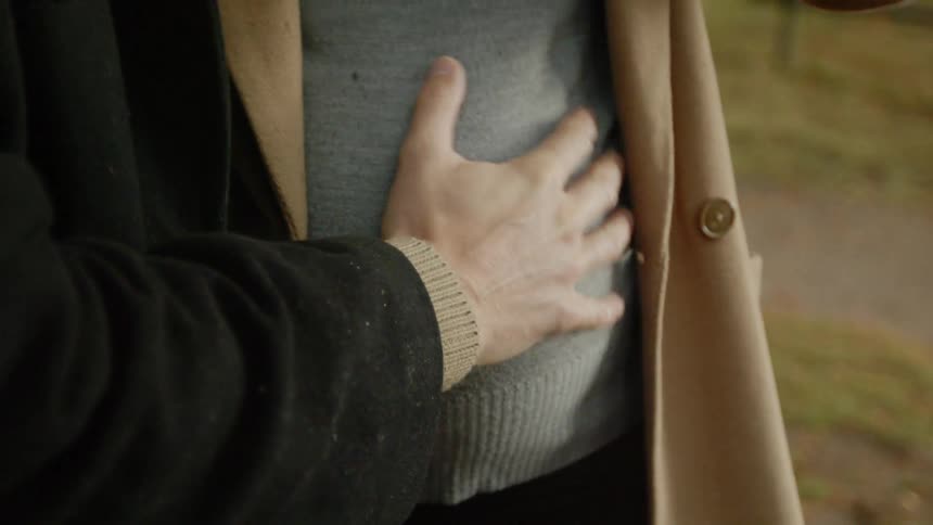 Expecting Couple Walking In The Forest