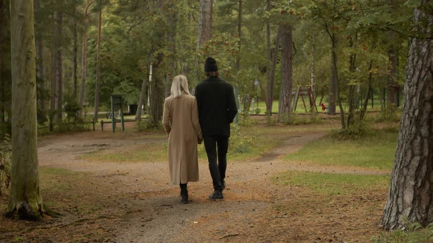 Expecting Couple Walking In The Forest