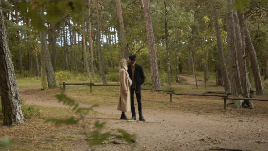 Expecting Couple Walking In The Forest