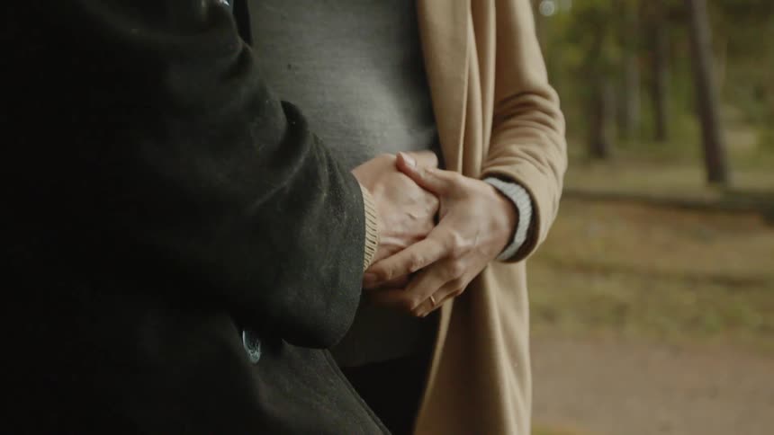 Expecting Couple Walking In The Forest