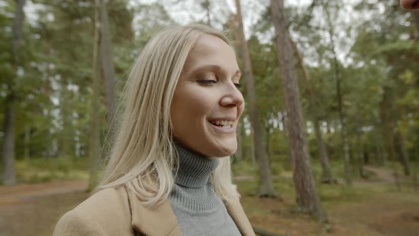 Expecting Couple Walking In The Forest