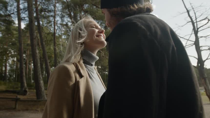 Expecting Couple Walking In The Forest