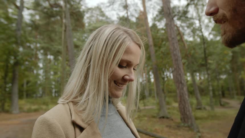 Expecting Couple Walking In The Forest