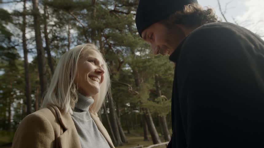 Expecting Couple Walking In The Forest