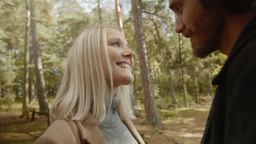 Expecting Couple Walking In The Forest