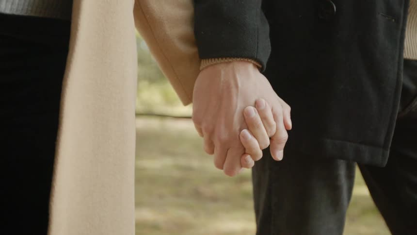Expecting Couple Walking In The Forest