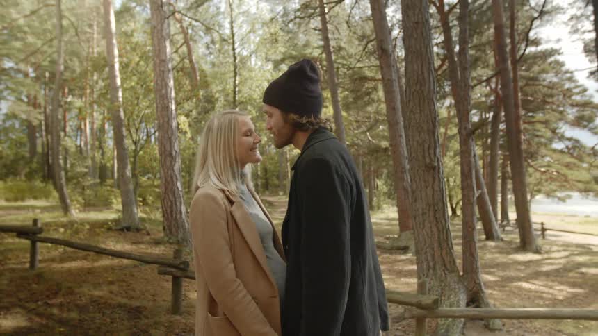 Expecting Couple Walking In The Forest