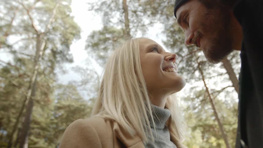 Expecting Couple Walking In The Forest