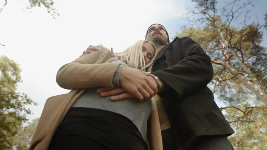Expecting Couple Walking In The Forest