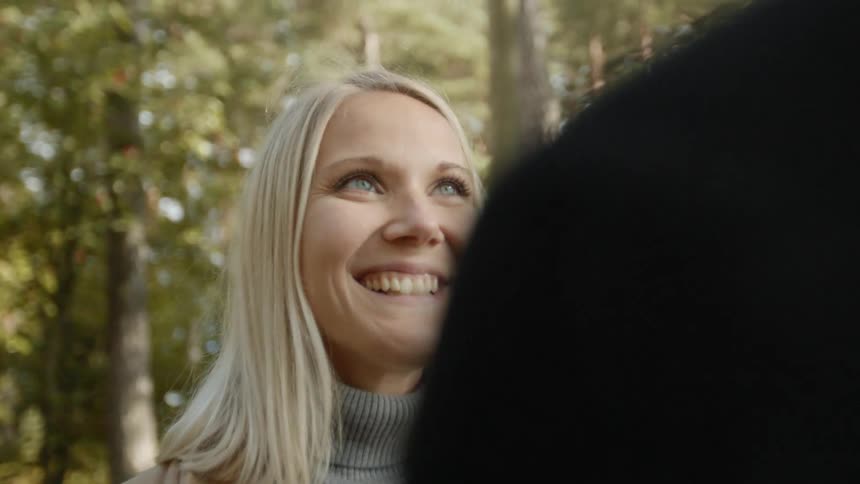 Expecting Couple Walking In The Forest