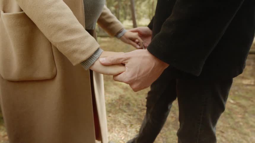 Expecting Couple Walking In The Forest