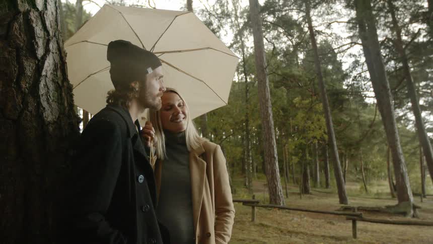 Expecting Couple Walking In The Forest