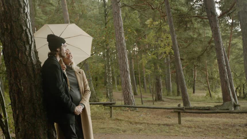 Expecting Couple Walking In The Forest