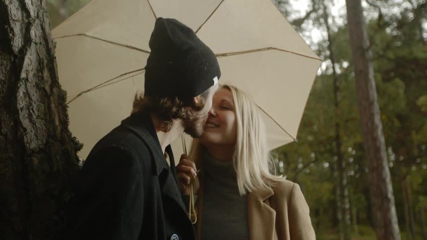 Expecting Couple Walking In The Forest
