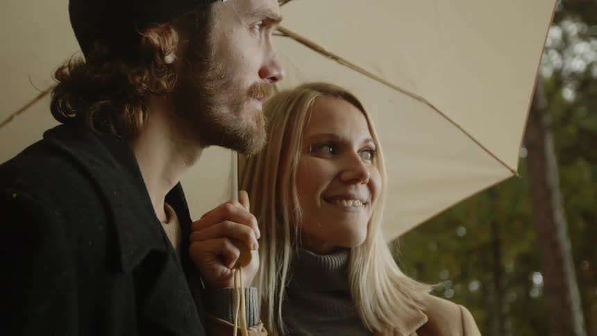 Expecting Couple Walking In The Forest