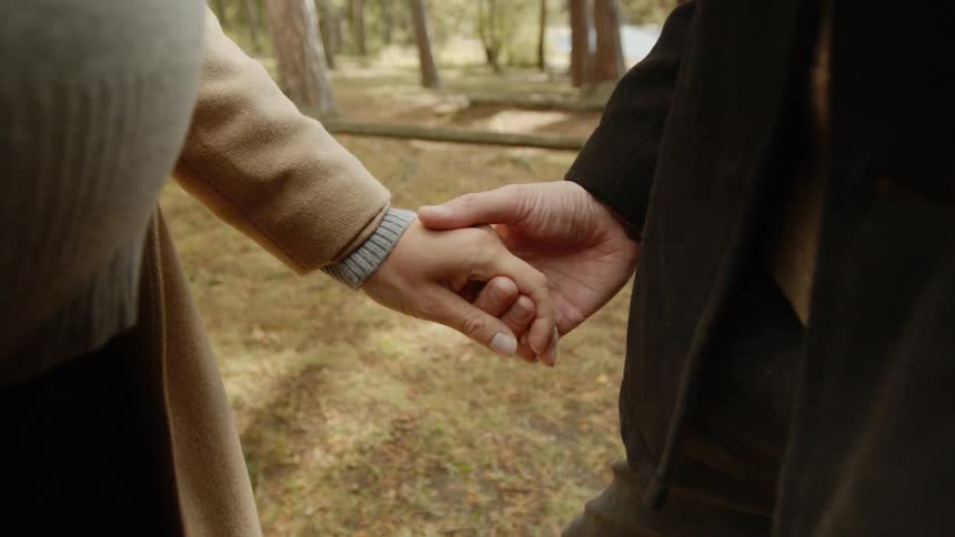 Expecting Couple Walking In The Forest