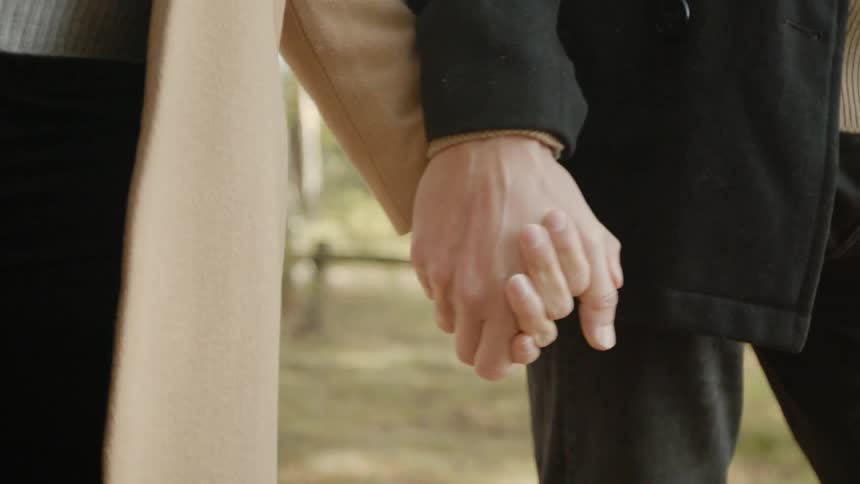 Expecting Couple Walking In The Forest