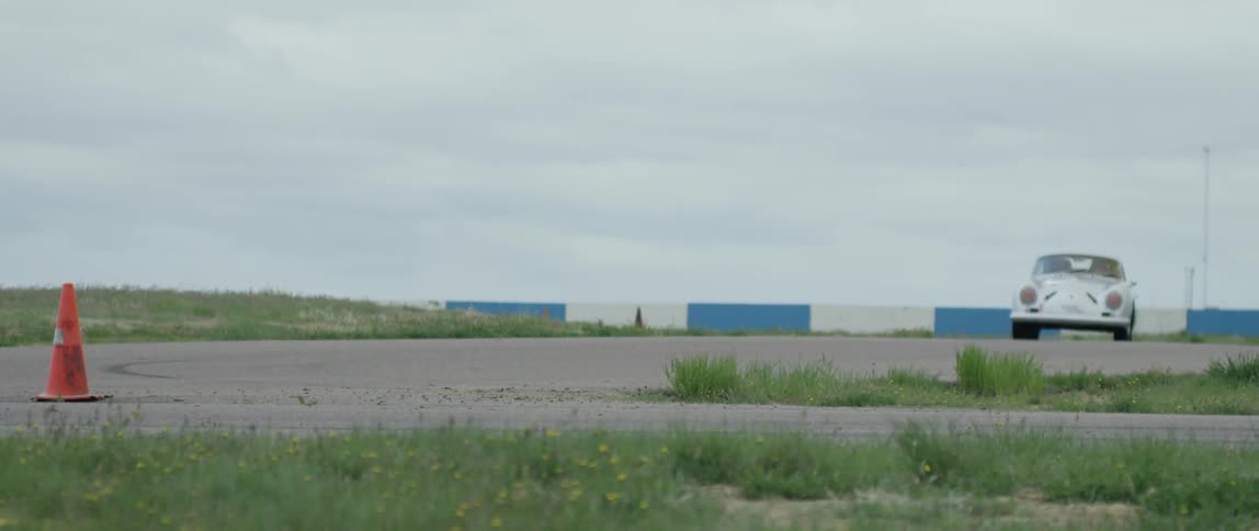 An old car racing through a road course
