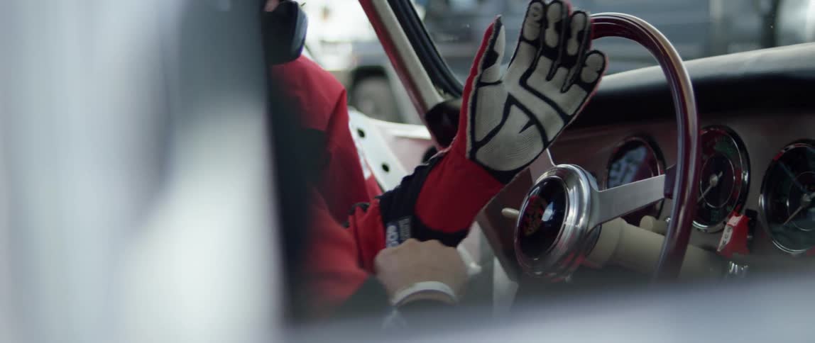 A person putting on race gloves