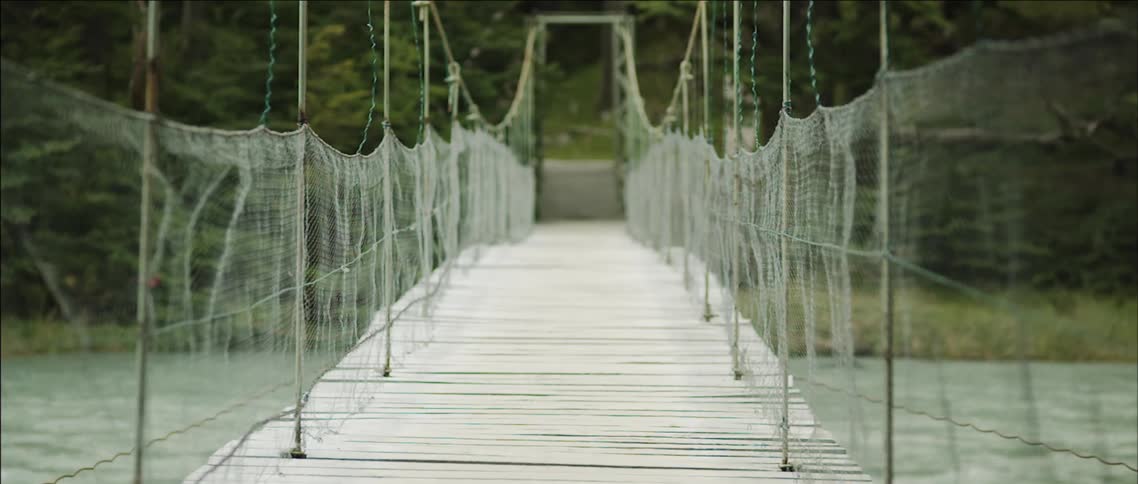 An empty bridge lines a body of water
