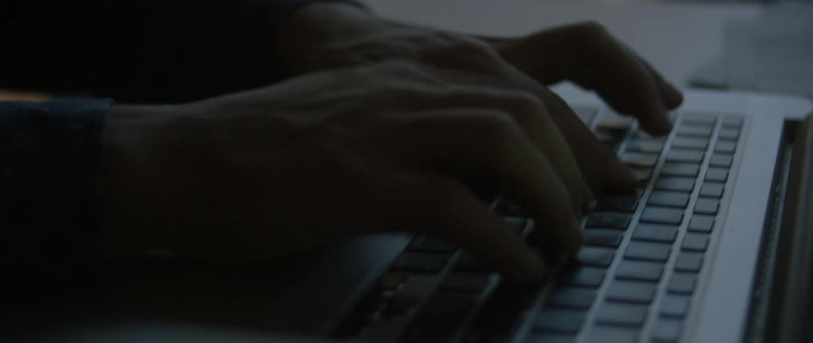 Hands typing on a keyboard