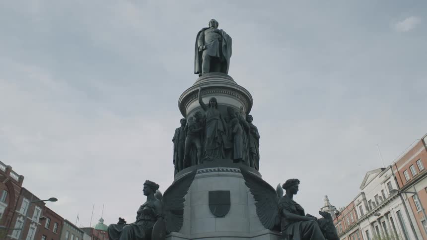 A large statue sits in a square on a cloudy day