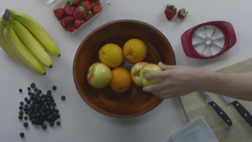People place fruit in bowl on table