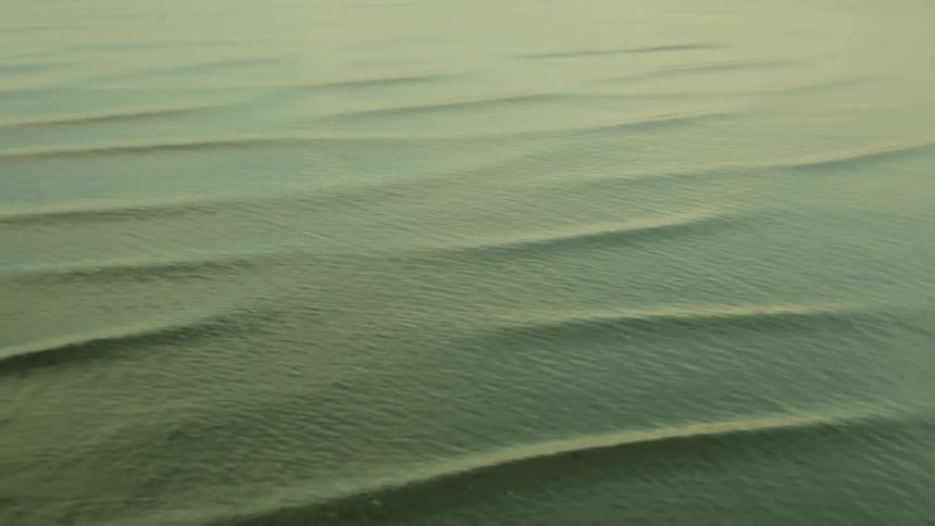 Water slowly rippling at sunset