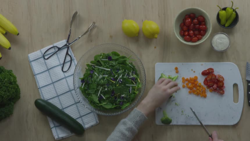 A person cutting broccoli