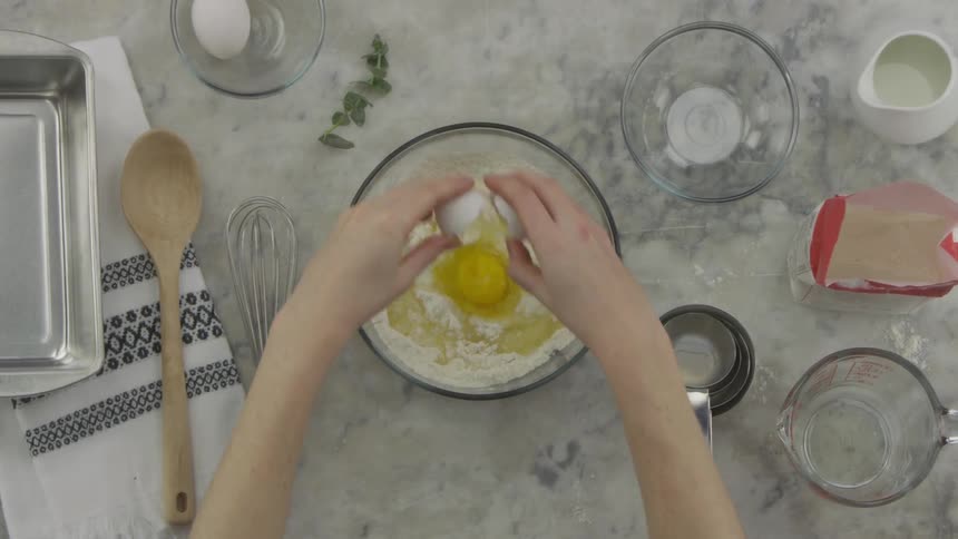 A person cracking an egg