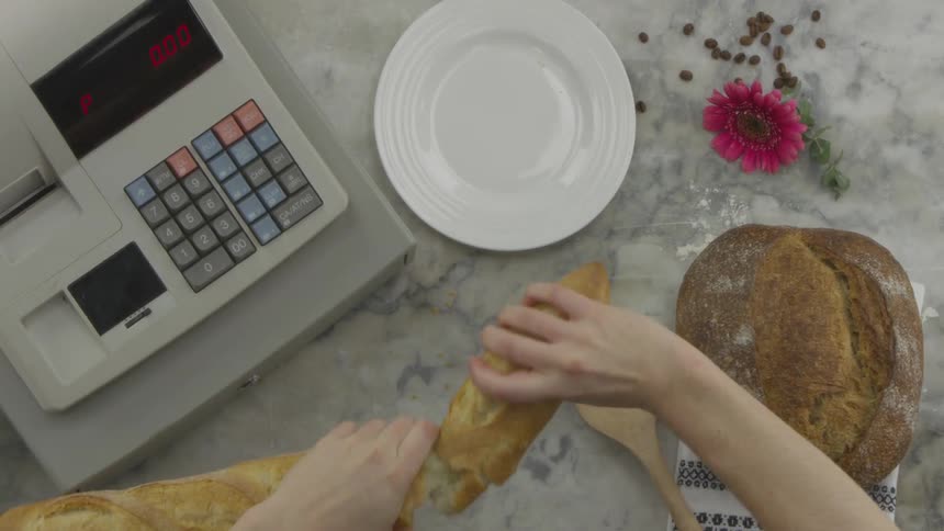 A person breaking bread apart