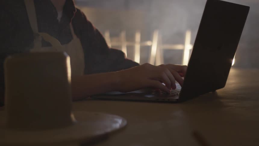 A person typing on a laptop