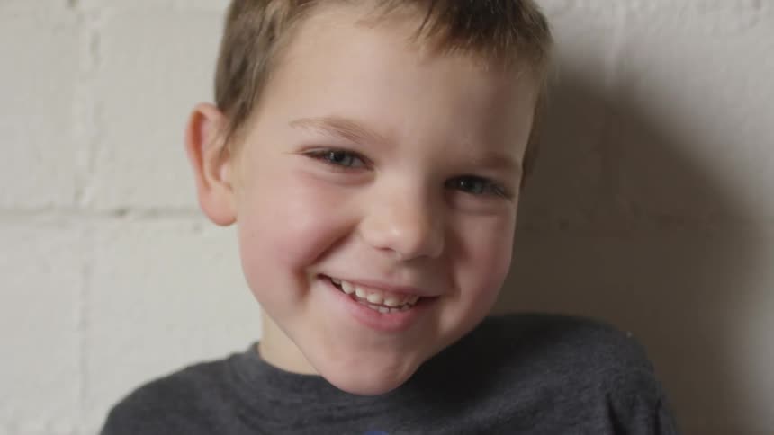 A child is smiling and laughing