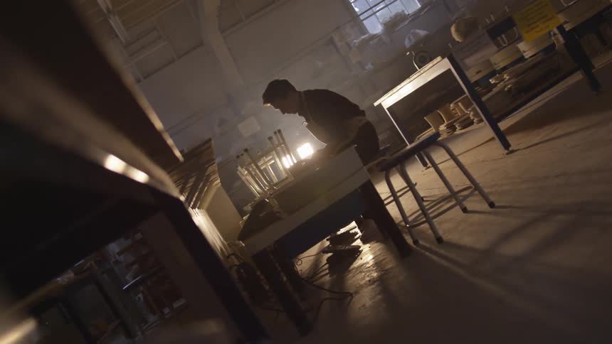 Man works at table at night