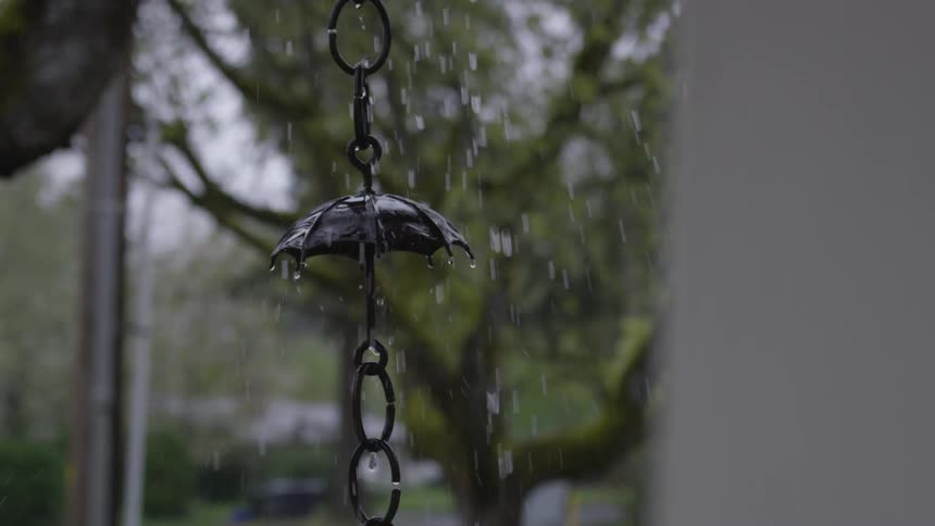 A metal porch decoration hanging in the rain