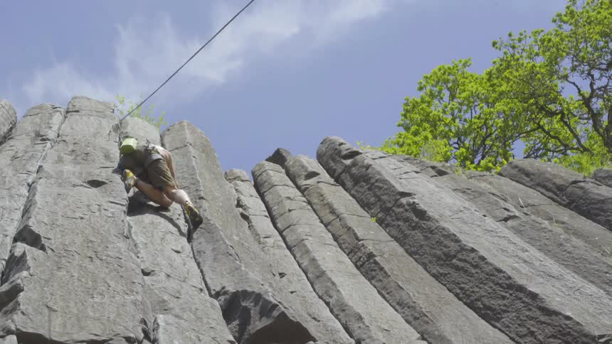 Man climbs toward top of cliff