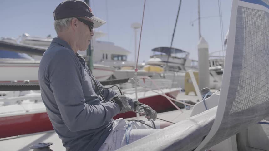 Man pulls a rope on a boat
