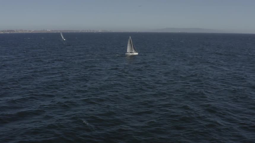 A boat sailing on the ocean over some waves