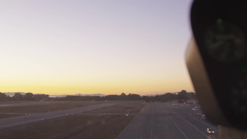 Airplane landing on runway at dusk