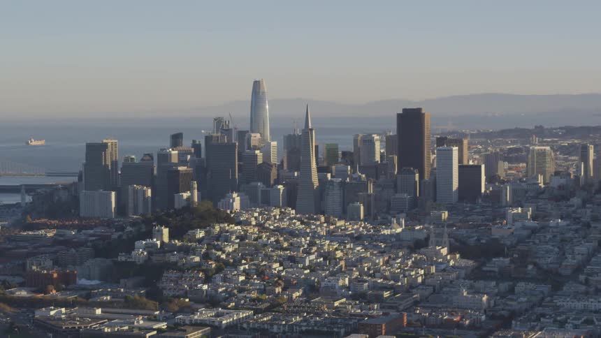 A coastal city's skyscrapers stand tall above the other buildings and city streets