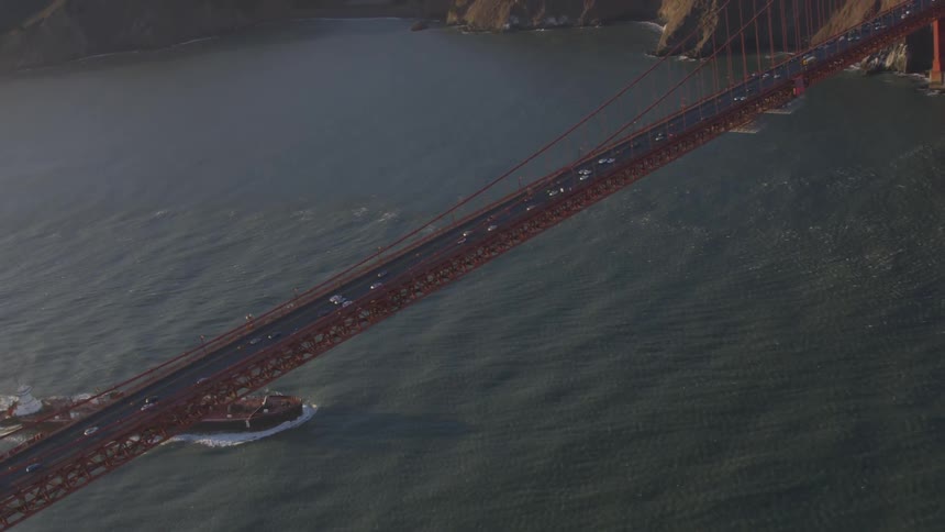 A cargo ship going under the golden gate bridge