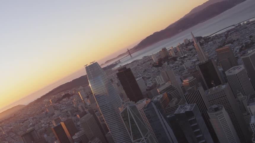San francisco skyline with the golden gate bridge in the distance during sunset