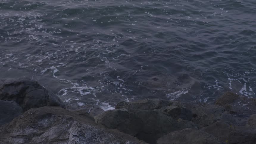 Water hitting some dark rocks