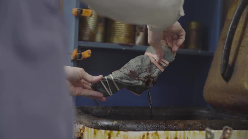 Person pours liquid into a rock then pours the liquid out of the rock
