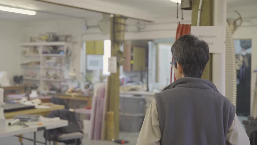 A man is walking in a workshop