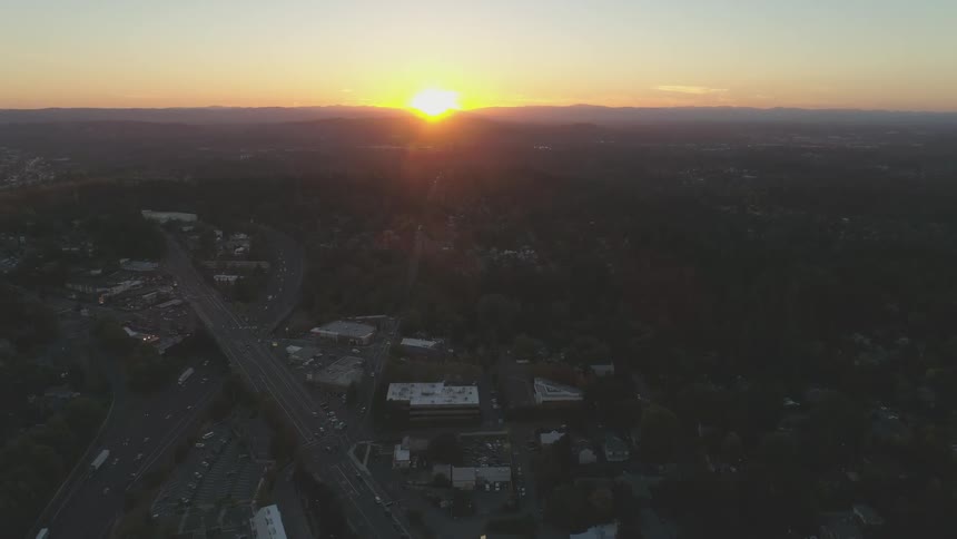 A road network and urban landscape viewed from the air at sunset