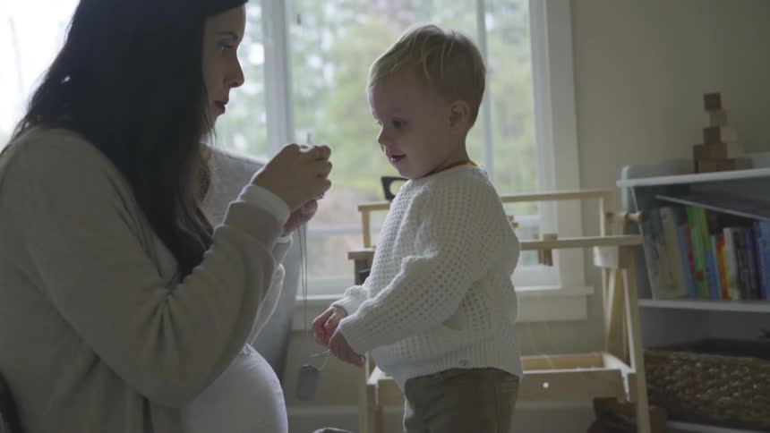 Mother and child gives dog tags to a child
