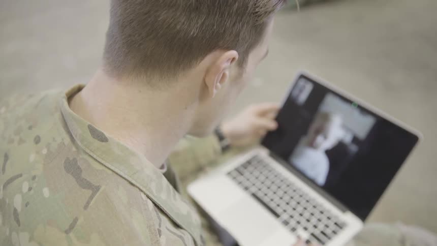 A soldier video chats with his daughter