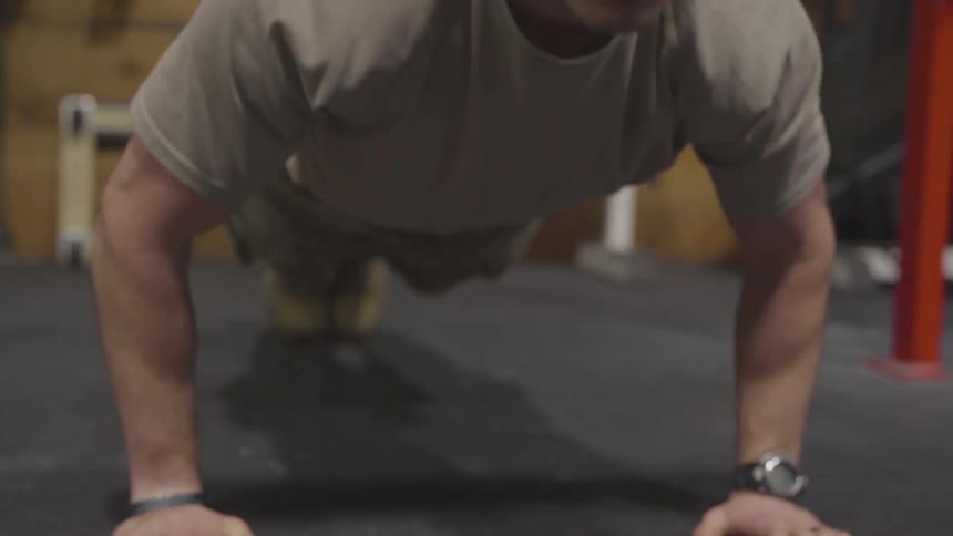A male doing push ups on the ground