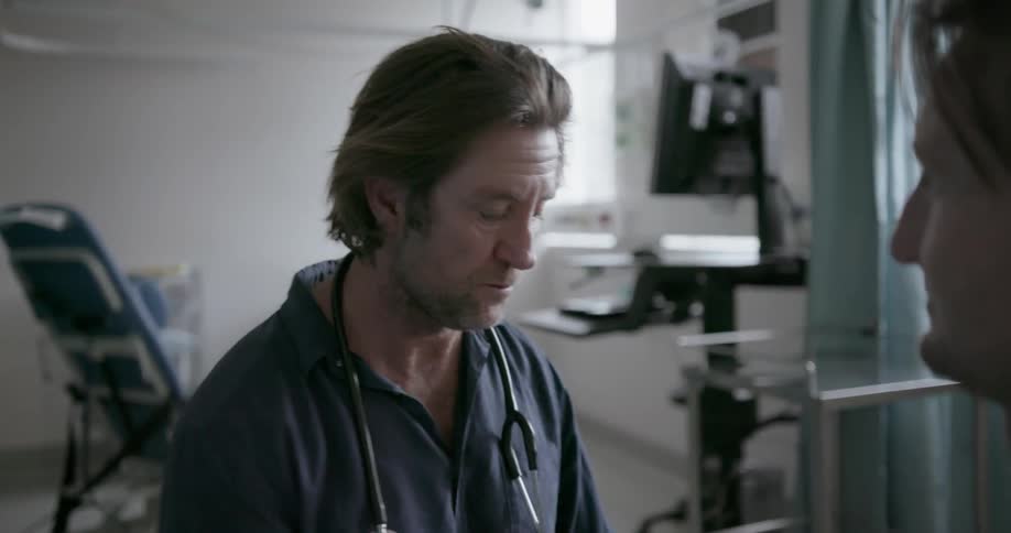 Doctor uses a stethoscope on a patient and takes notes